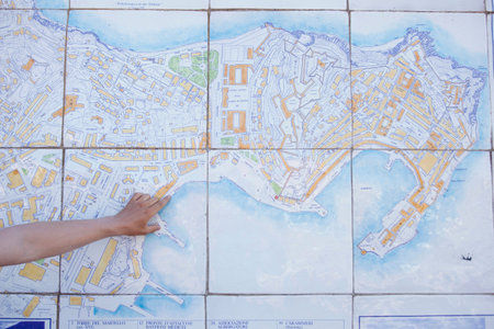 Man pointing with finger on tiled mapの写真素材