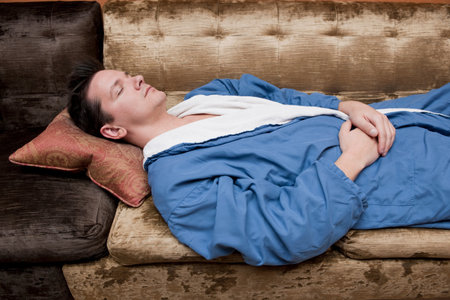 man relaxing in bath robesの写真素材