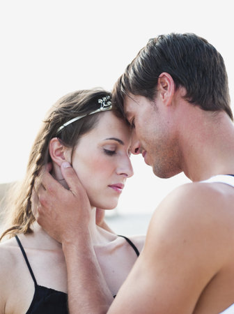 couple embracing on the beachの写真素材
