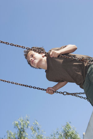 Young boy on swingの写真素材