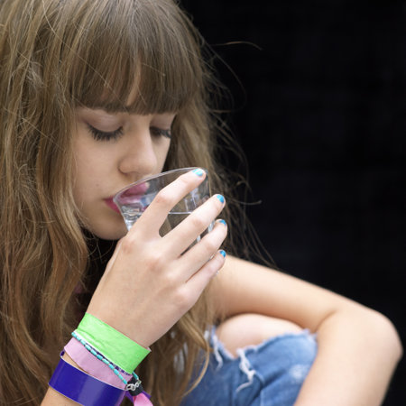 young woman drinking from a glassの写真素材