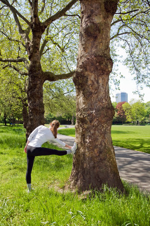 A young woman warming up before joggingの写真素材