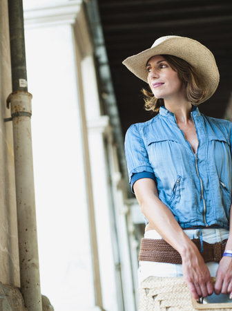 woman with hat looking aroundの写真素材