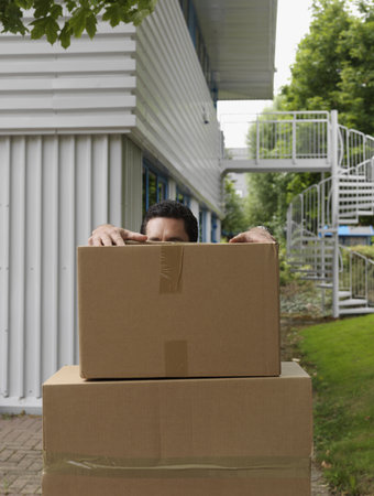 man with stack of boxesの写真素材