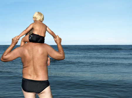 Grandfather with boy on shouldersの写真素材