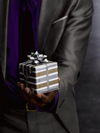 Business man offering giftの写真素材