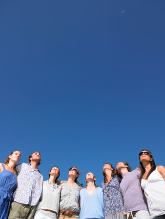 group of young people looking at sun