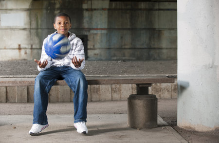 Boy sitting with ballの写真素材