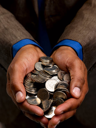 Business man with handful of coinsの写真素材