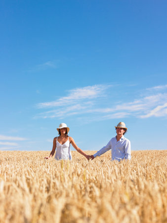 young couple in wheat fieldの写真素材