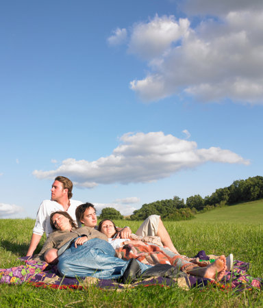 young people lying in fieldの写真素材
