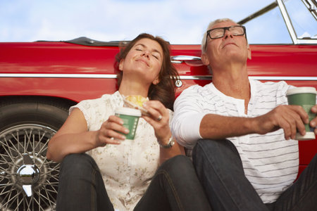 Couple with car, coffee breakの写真素材