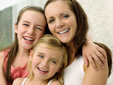 A portrait of a mother and two daughtersの写真素材