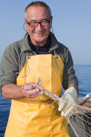 fisherman on boat, trawling, smilingの写真素材