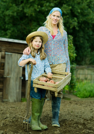 A woman and girl in a gardenの写真素材