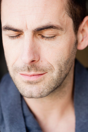 man listening with eyes closed