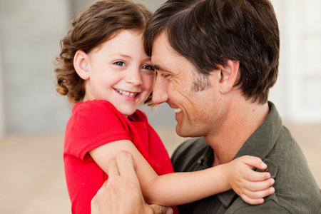 father tickling daughterの写真素材