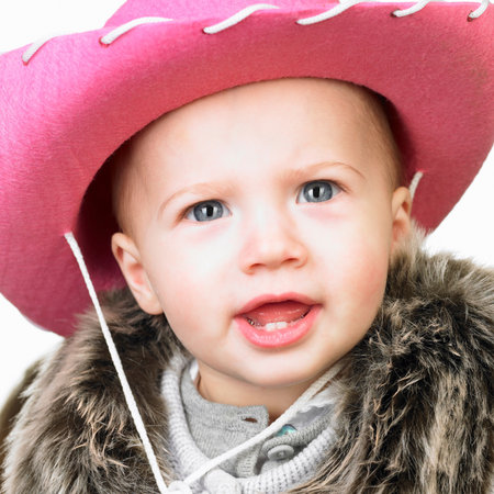 Baby girl with cowgirl hat on her headの写真素材