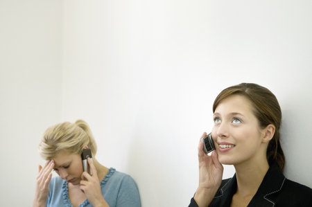 Business colleagues on their phonesの写真素材