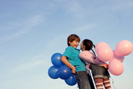 Kids laughing with balloonsの写真素材