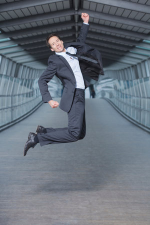 businessman jumping into airの写真素材