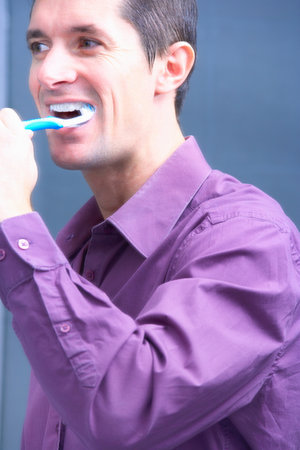 man brushing his teeth, head croppedの写真素材