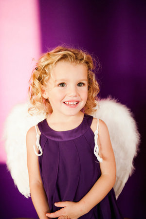 young girl in angel costumeの写真素材