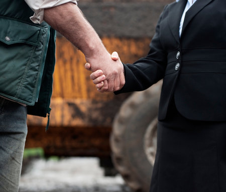 business woman shaking hands with farmerの写真素材