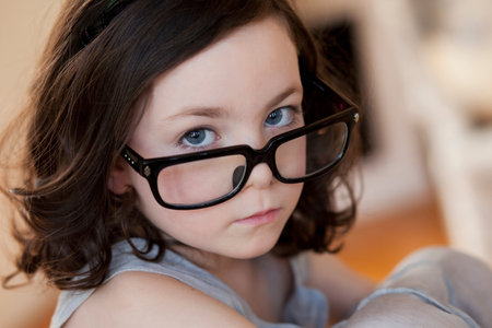 little girl wearing huge pair of glassesの写真素材