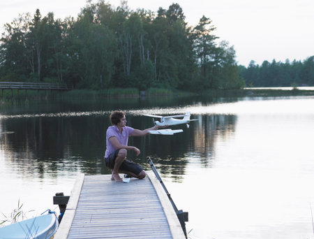 Man with a remote-controlled planeの写真素材