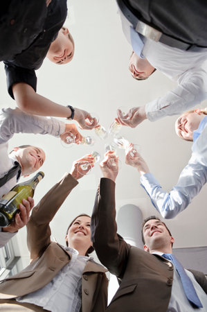 Happy business executives with champagneの写真素材