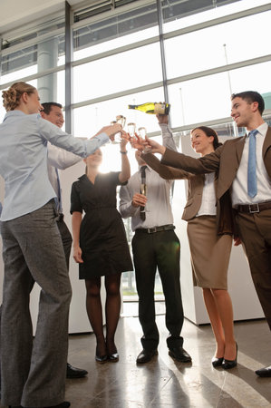 Happy business executives with champagneの写真素材
