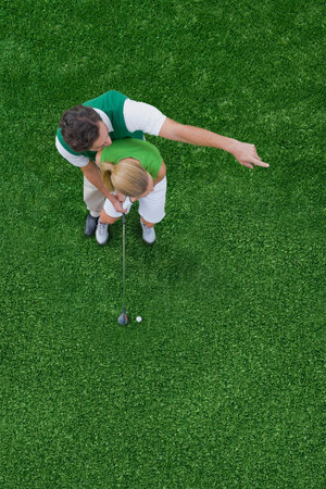 Couple playing golfの写真素材