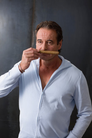 Man taking a smell at a cigar