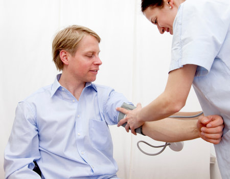 Doctor patient taking blood pressureの写真素材