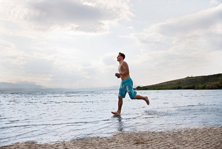 Man running at beachの写真素材