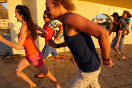 Happy young people runningの写真素材