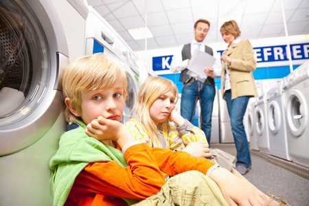 Children are bored of washing machinesの写真素材