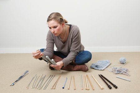 Woman selecting knitting needlesの写真素材