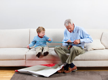Boy and grandfather with new fishing rodの写真素材