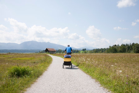 Men cycling with trailerの写真素材