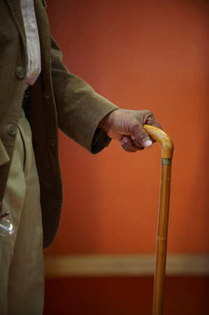 Elderly man's hand on walking stickの写真素材