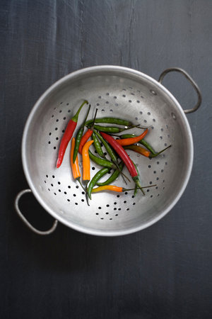 Mixed color chilies on colander