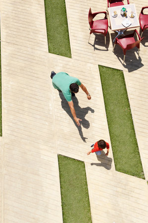 Father chasing young sonの写真素材