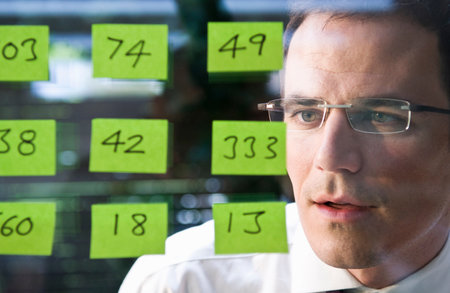 Man looks at yellow stickersの写真素材