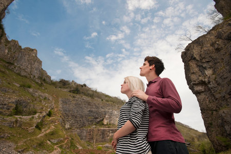 Couple looking up in valleyの写真素材