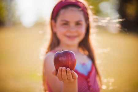 Young girl holding apple