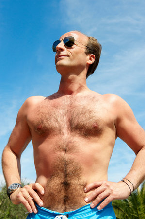 Man without his shirt, shot from belowの写真素材