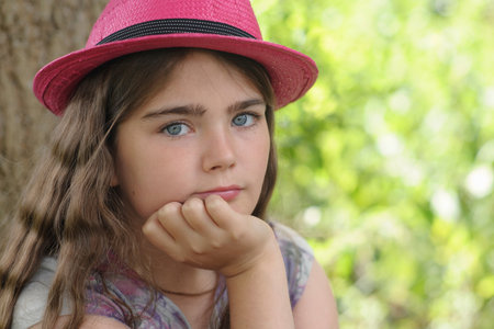 Portrait of young girl in pink hat