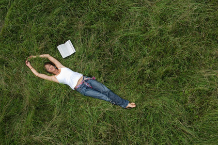 Female relaxing in fieldの写真素材